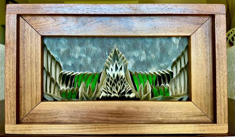 Mallard wing panel in a black walnut frame — green speculum feathers fanned in a symmetrical mountain composition