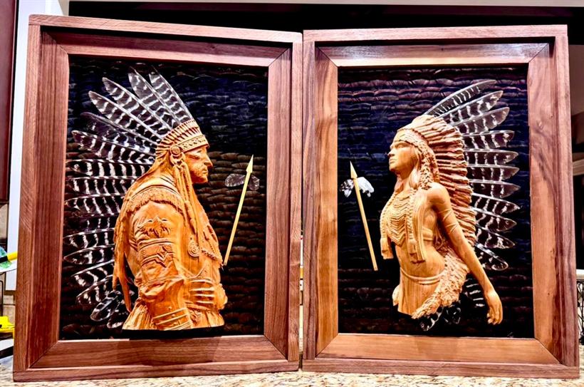 The Native American series — carved chief and maiden reliefs with arrows, set against black feather fields in walnut frames